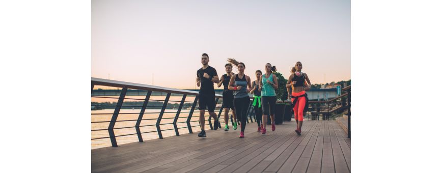 Group of runners running across a bridge